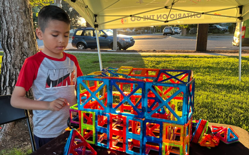 Child building with kinetic shapes